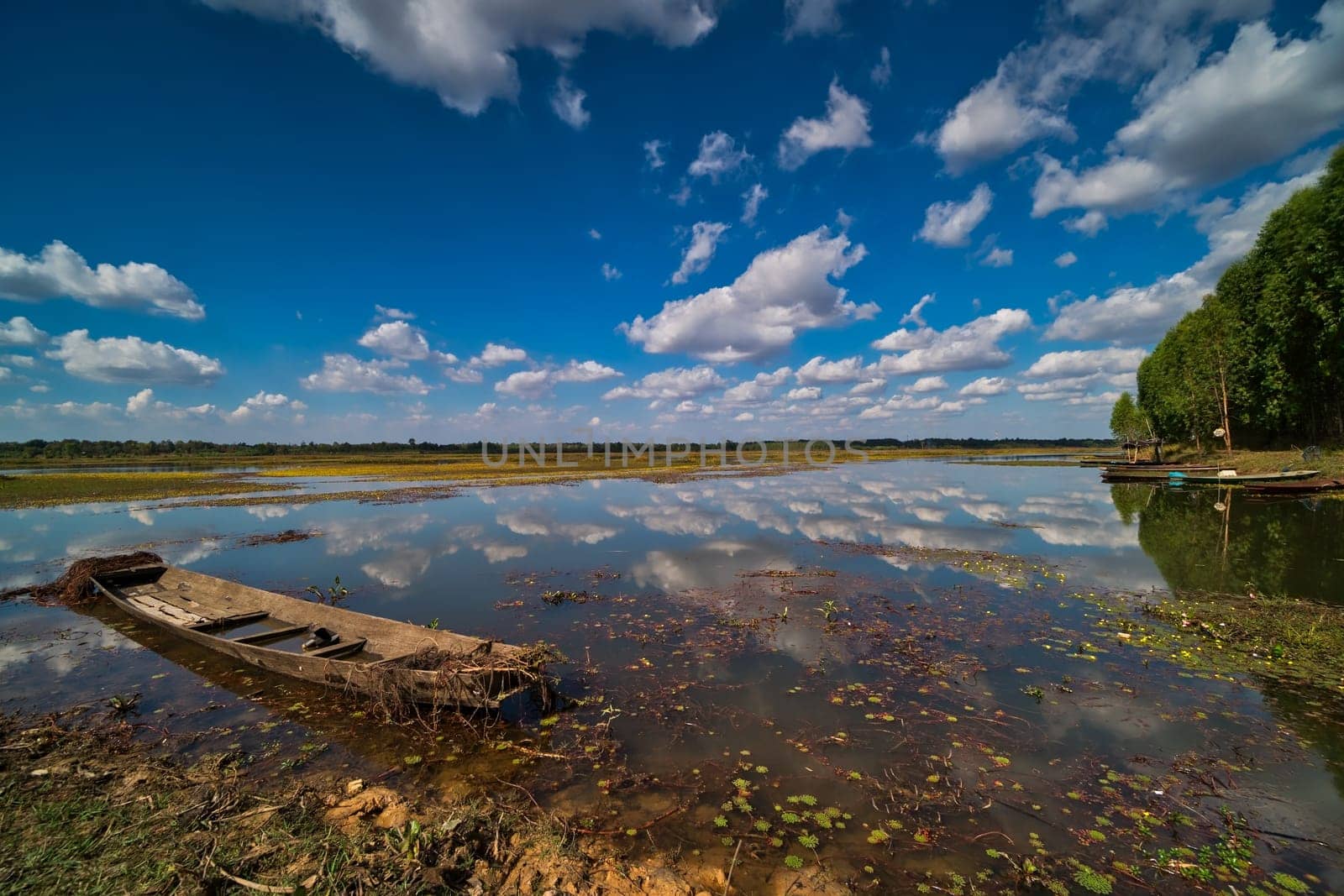 Lake With Reflection, landscape with fishing boat and cumulus clouds