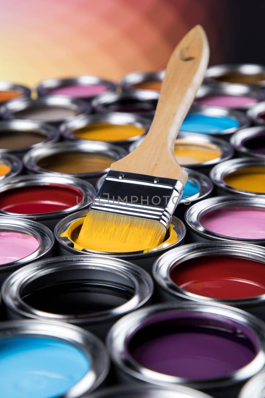 Paintbrush on cans with color