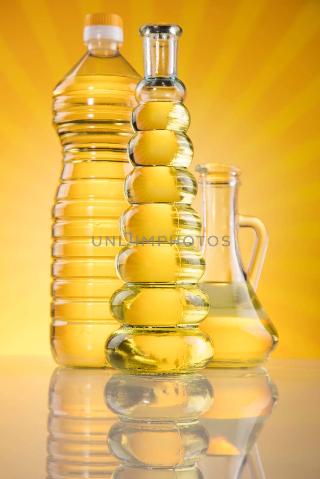 Olive oil, rapeseed oil, sunflower oil on sunburst orange background