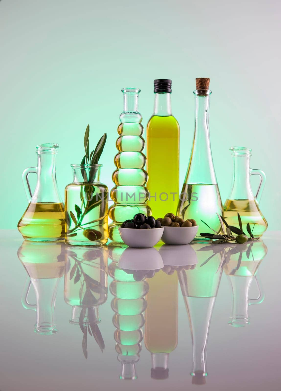 Bottles with organic cooking olive oil and olive branch
