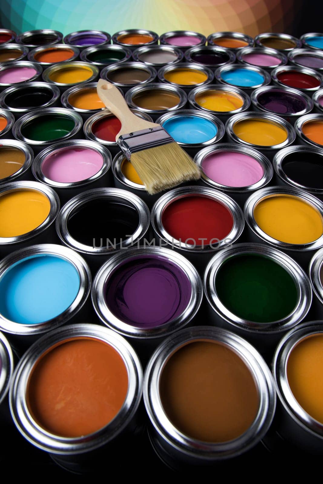 Paintbrush on cans with color