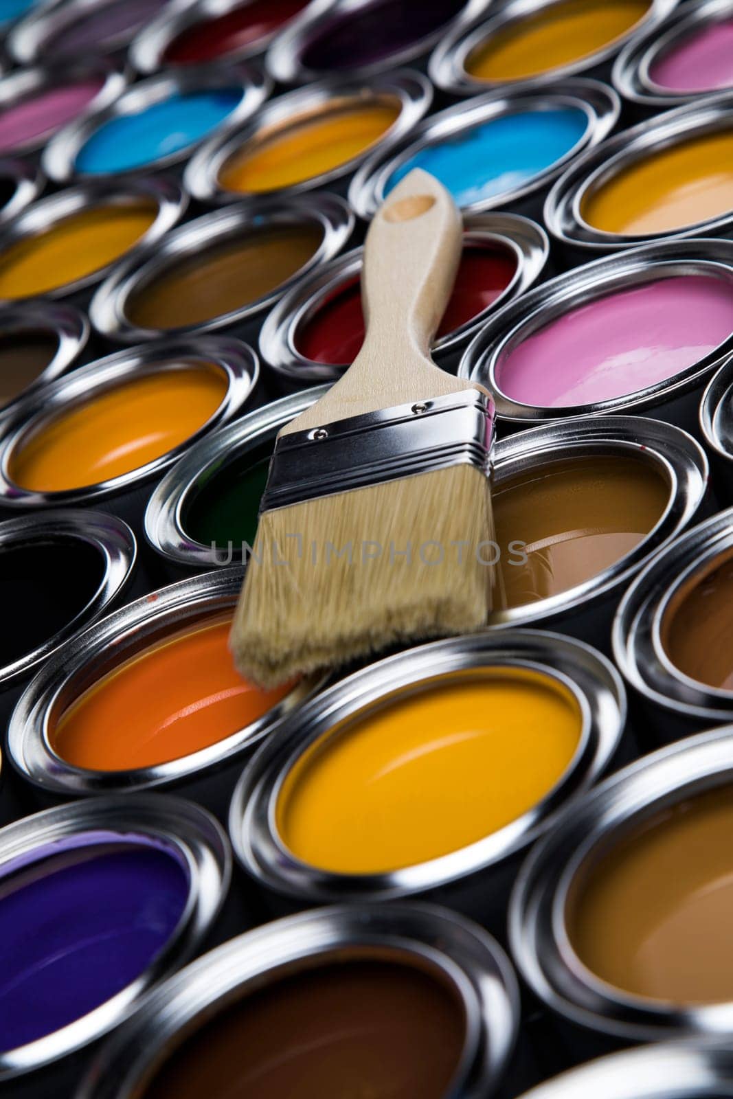 Metal tin cans with color paint and paintbrush