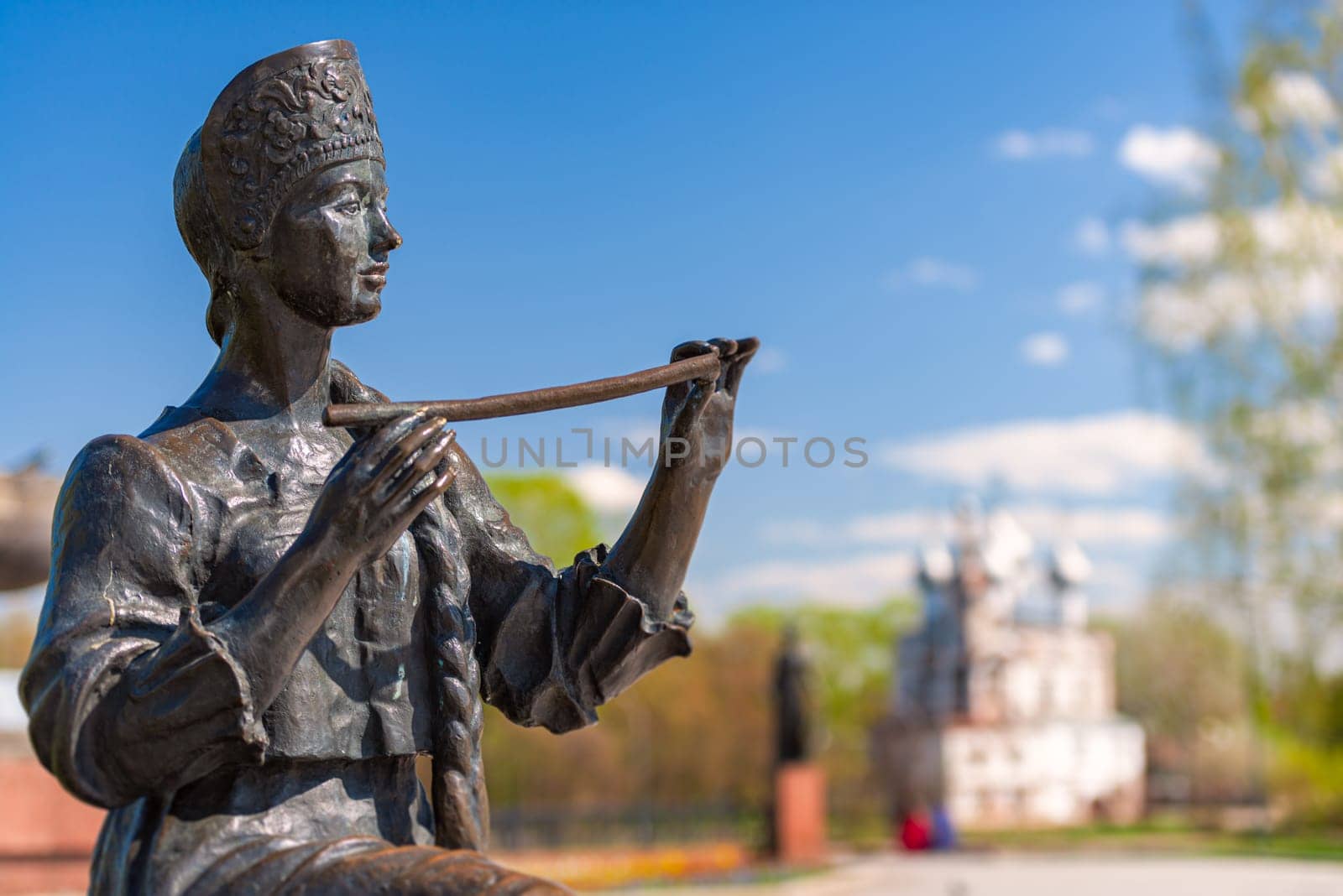 Momnument in  Vologda near Kremlin. Russia, Europe. Church in background, sunny day