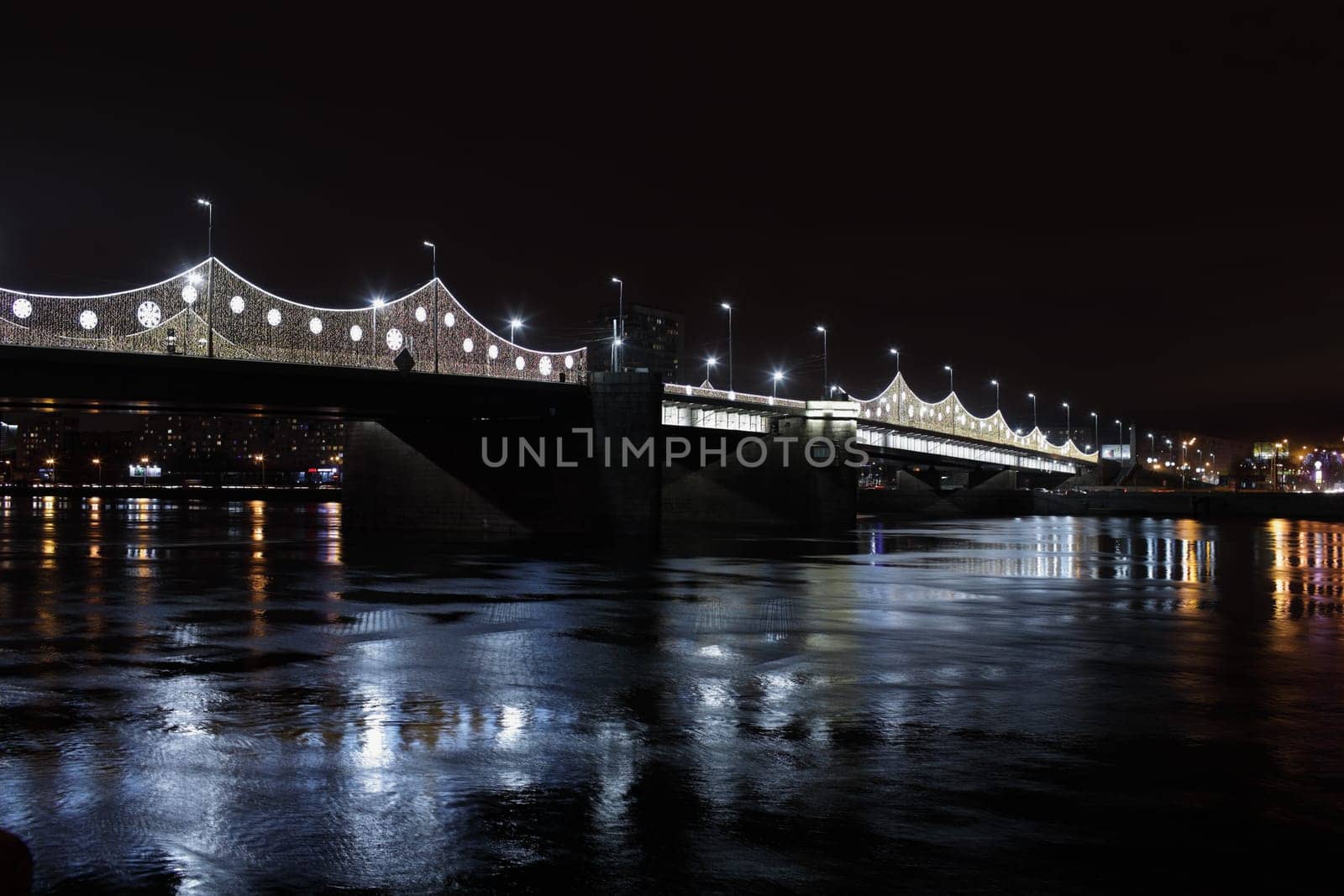 Drawbridge across the Neva River with illumination in St. Petersburg at night