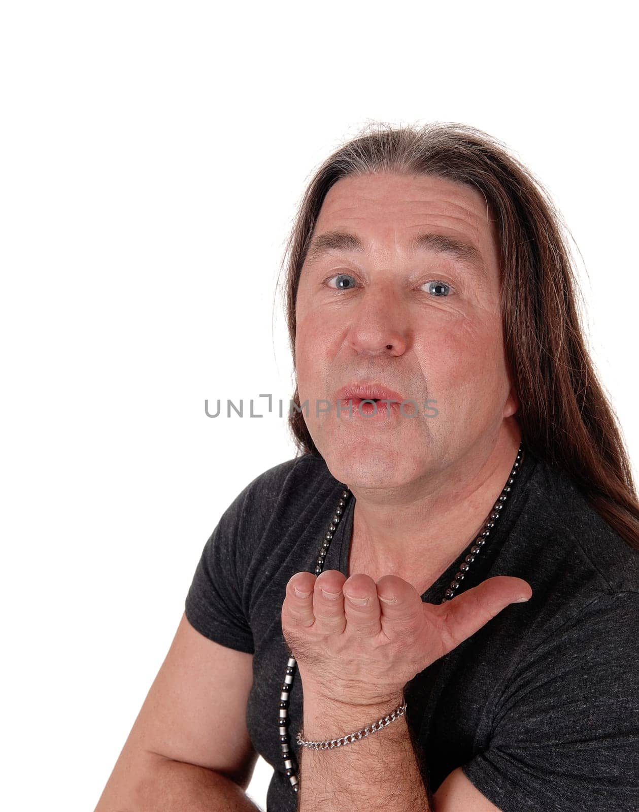 A image of a middle age indigenous man standing.and blowing a kiss, isolated for white background.