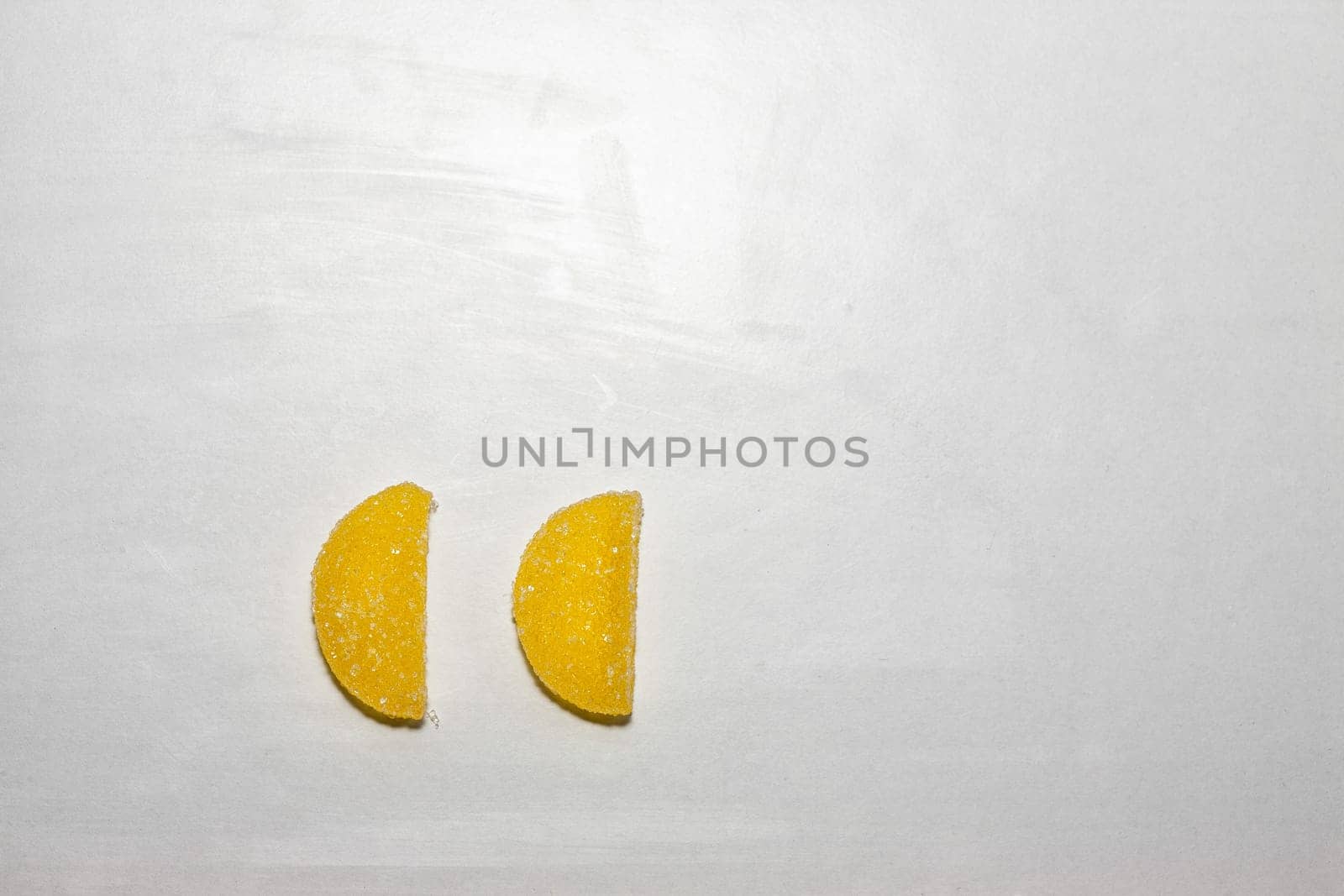 Two Sugar candies shaped as half moon.