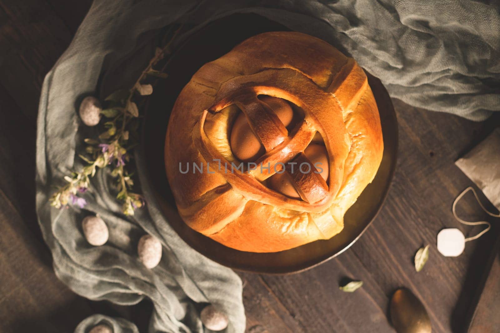 Easter folar with egg on wooden table top.