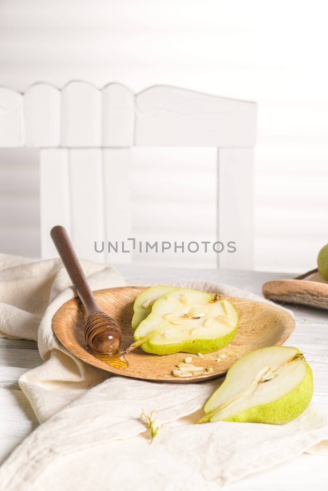 Tasty pears with honey and nuts on wooden table.