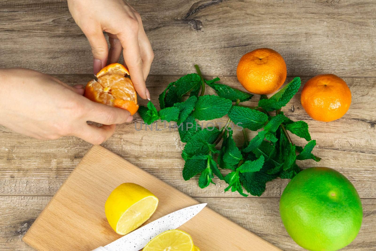 People eat pizza at festive table served for party. Friends celebrate with catering food on wooden table top view. Woman and man's yands take the pieces of italian pizza.