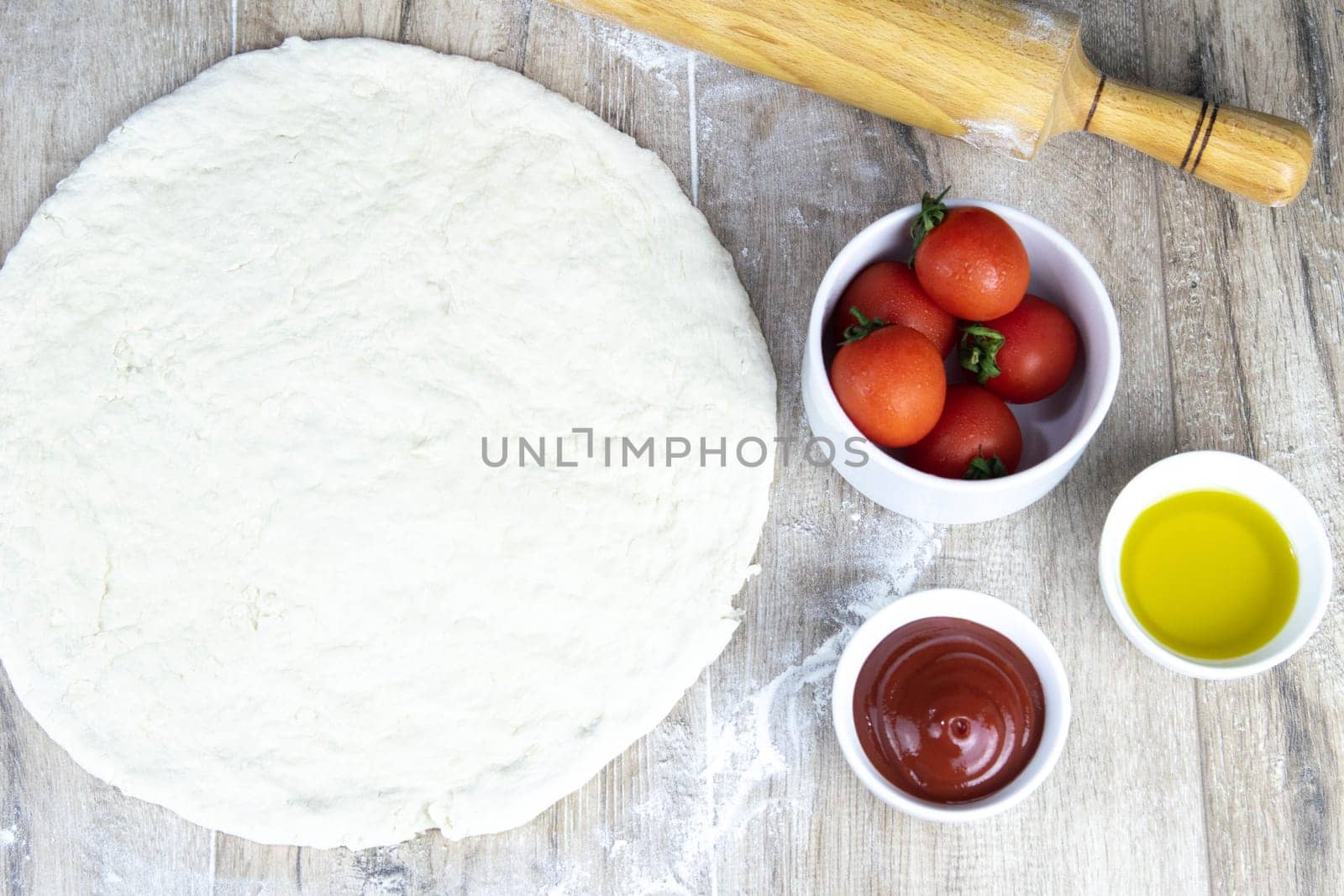 People eat pizza at festive table served for party. Friends celebrate with catering food on wooden table top view. Woman and man's yands take the pieces of italian pizza.