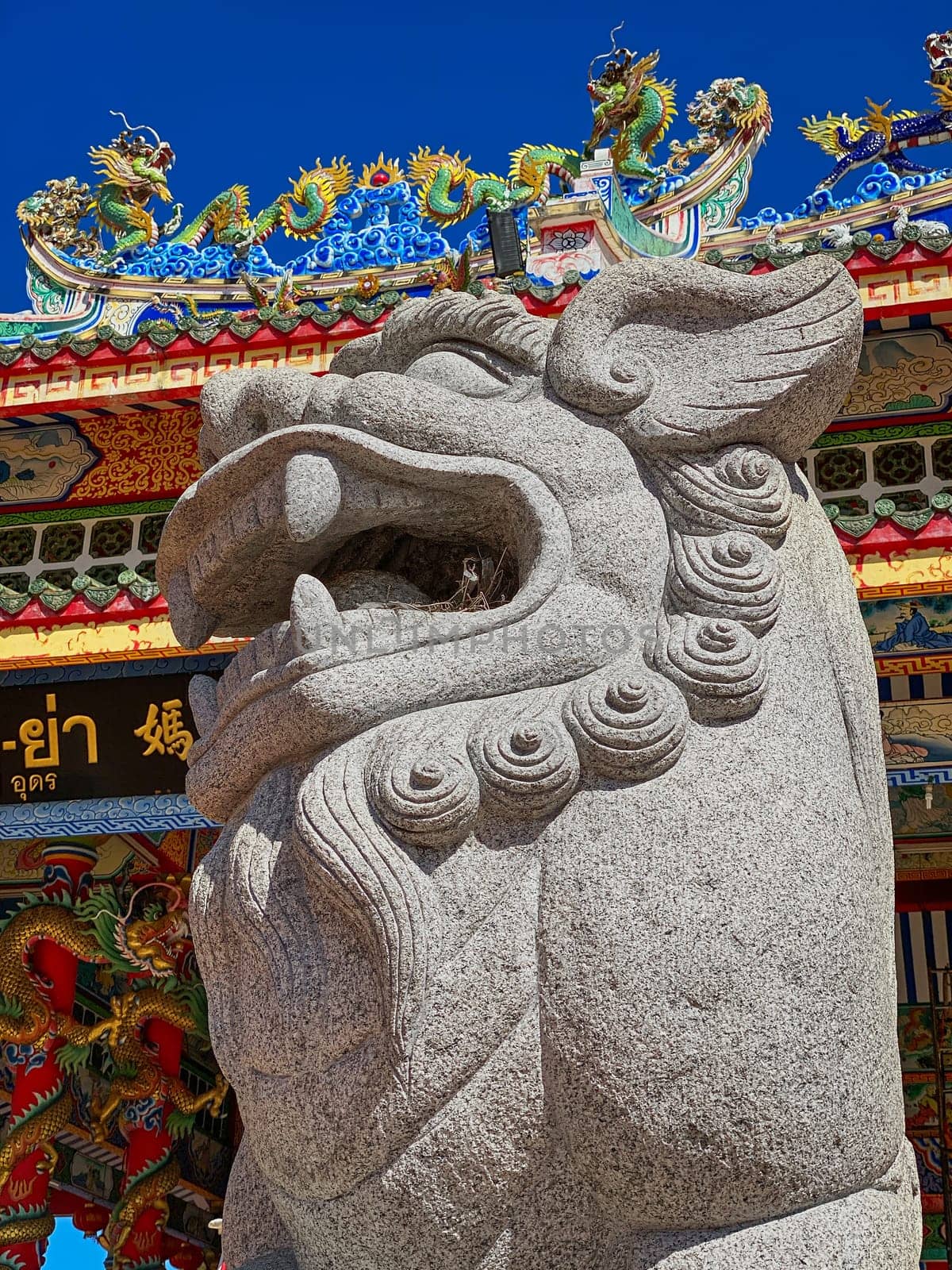 Chinese Lion Figurine, stone sculpture in front of Chinese temple