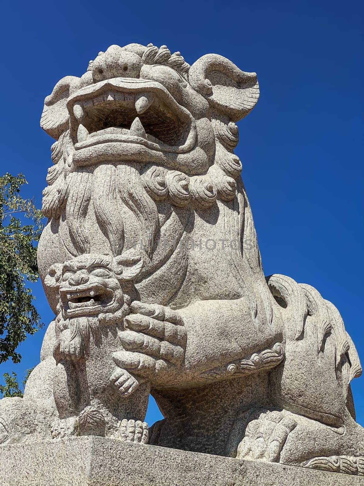 Chinese Lion Figurine, stone sculpture in front of Chinese temple