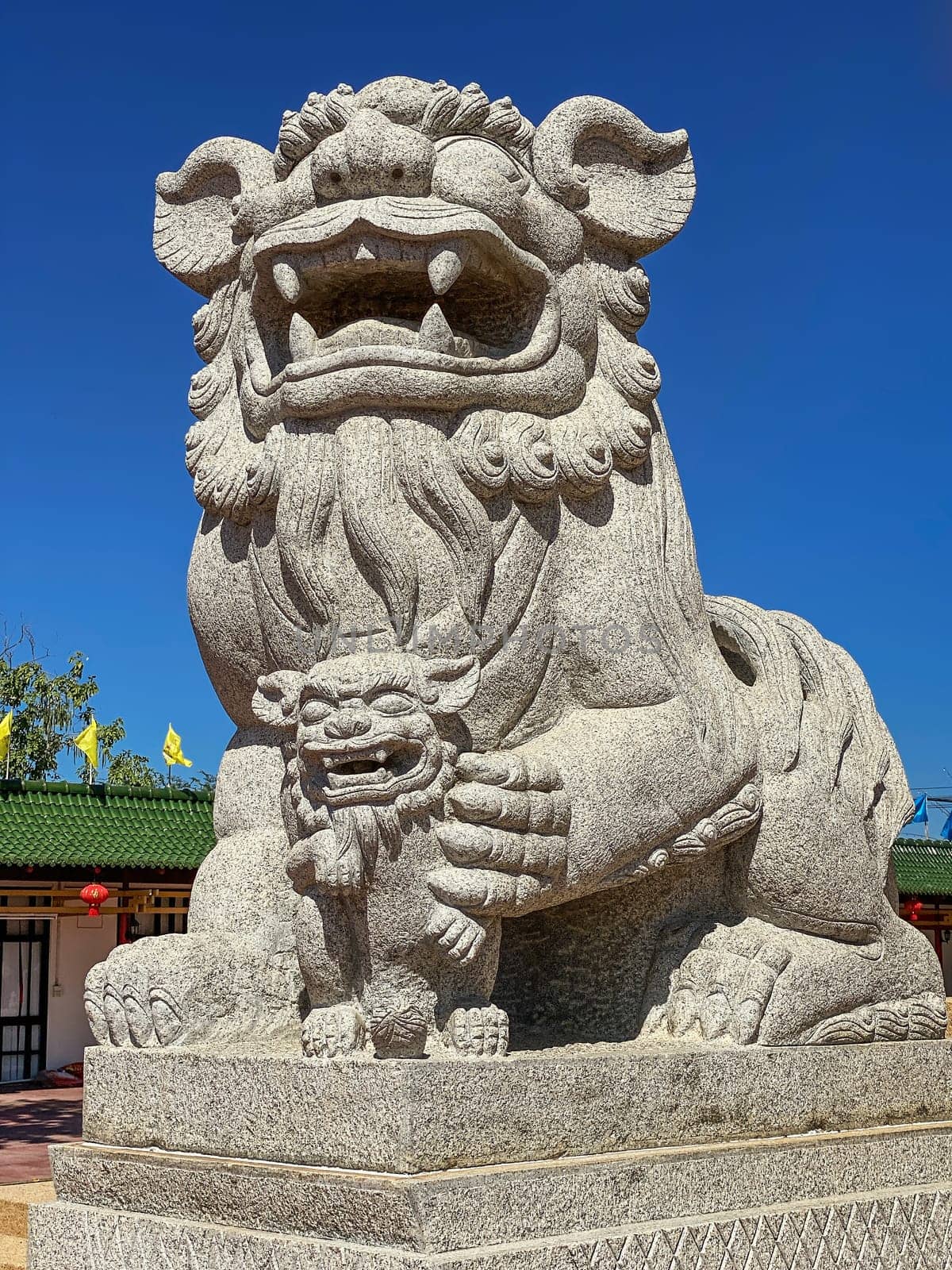 Chinese Lion Figurine, stone sculpture in front of Chinese temple
