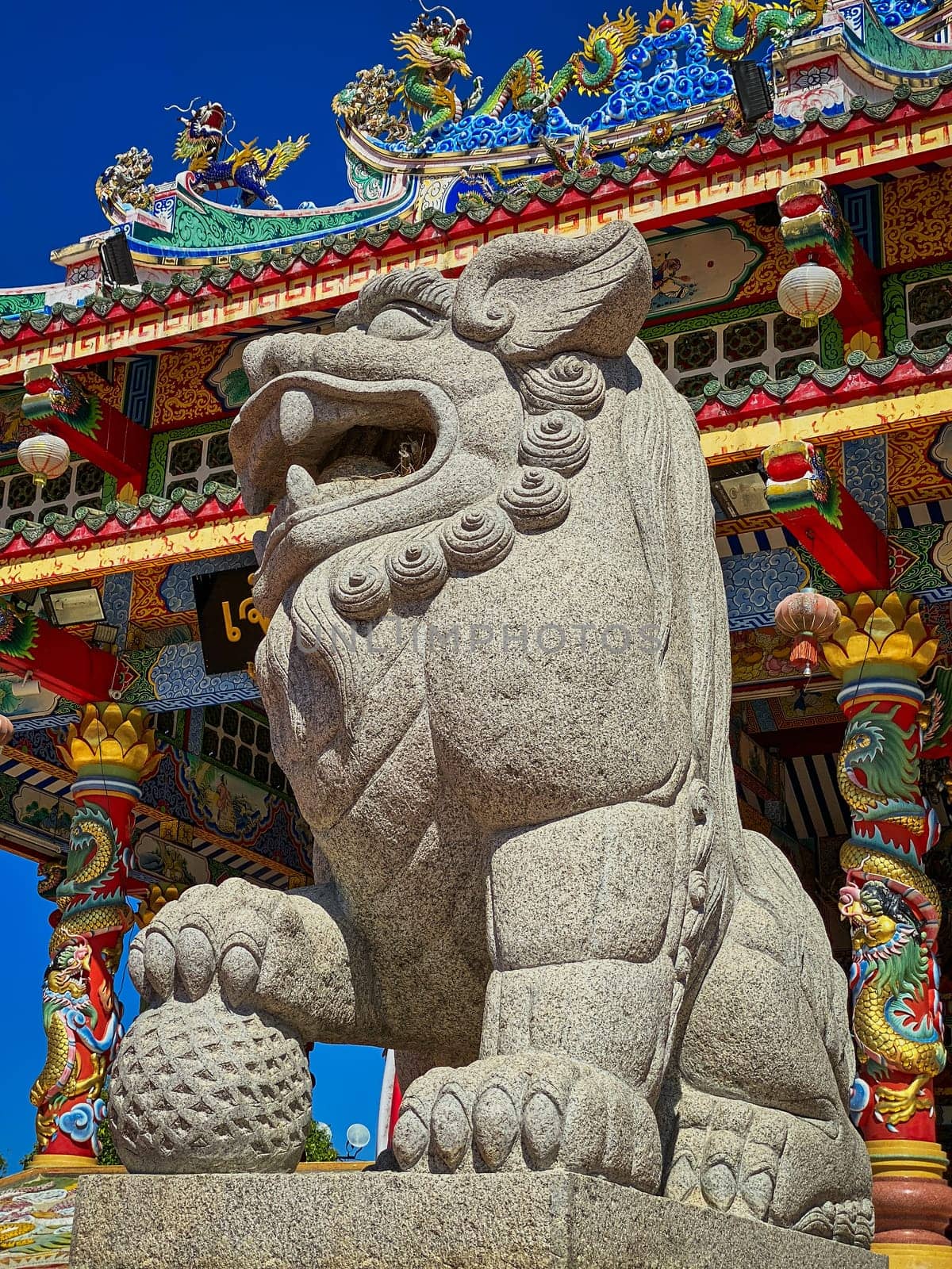 Chinese Lion Figurine, stone sculpture in front of Chinese temple