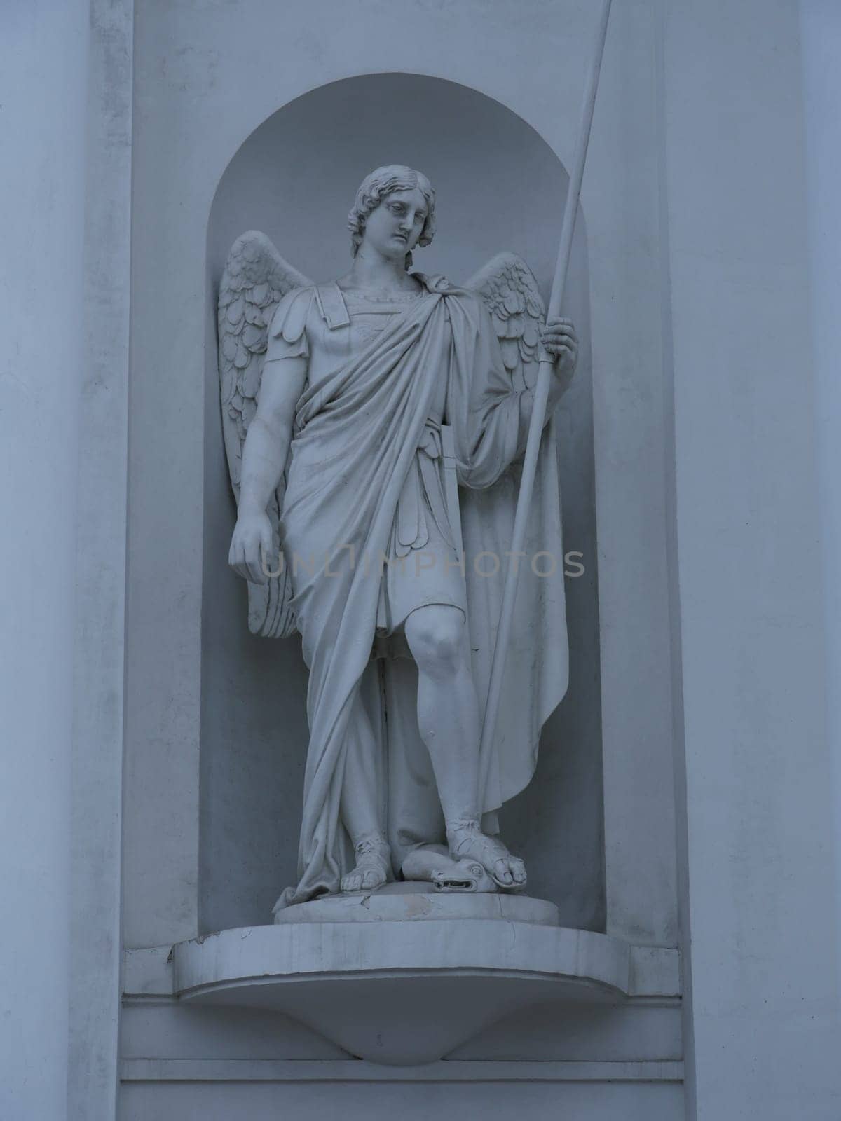 Statue of Archangel Michael with a spear striking a snake