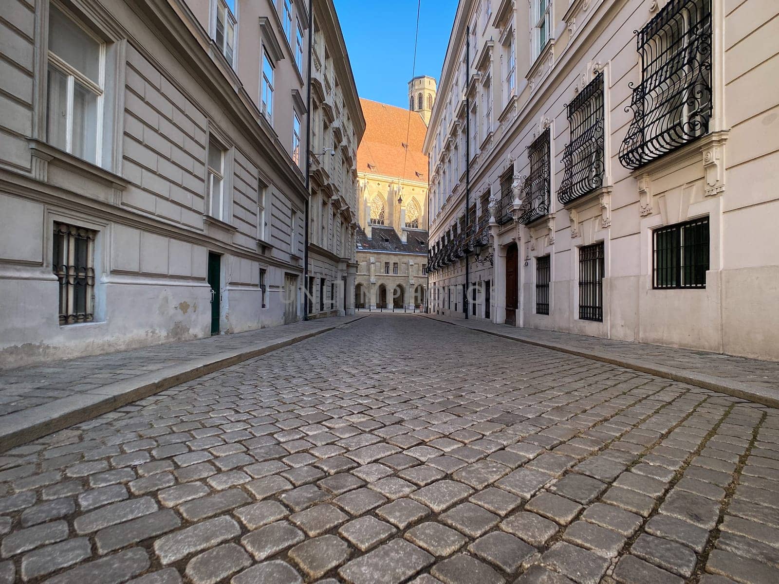 Historic Vienna, cobblestone street called Metastasiogasse with Minoritenkirche