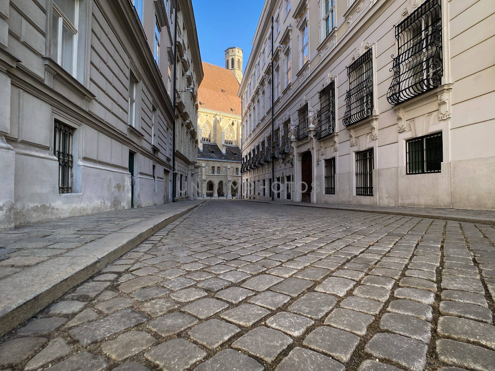 Historic Vienna, cobblestone street called Metastasiogasse with Minoritenkirche