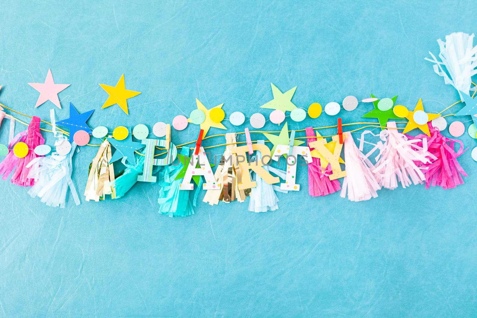 Cheerful decorations and party garlands on a blue background
