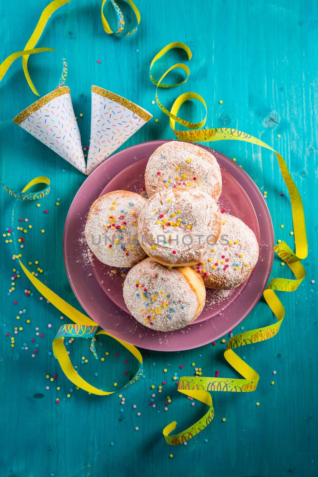 Carnival powdered sugar raised donuts - German Berliner donuts, Krapfen filled with jam