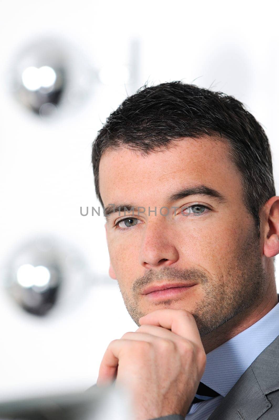 An attractive business man in a light business environment