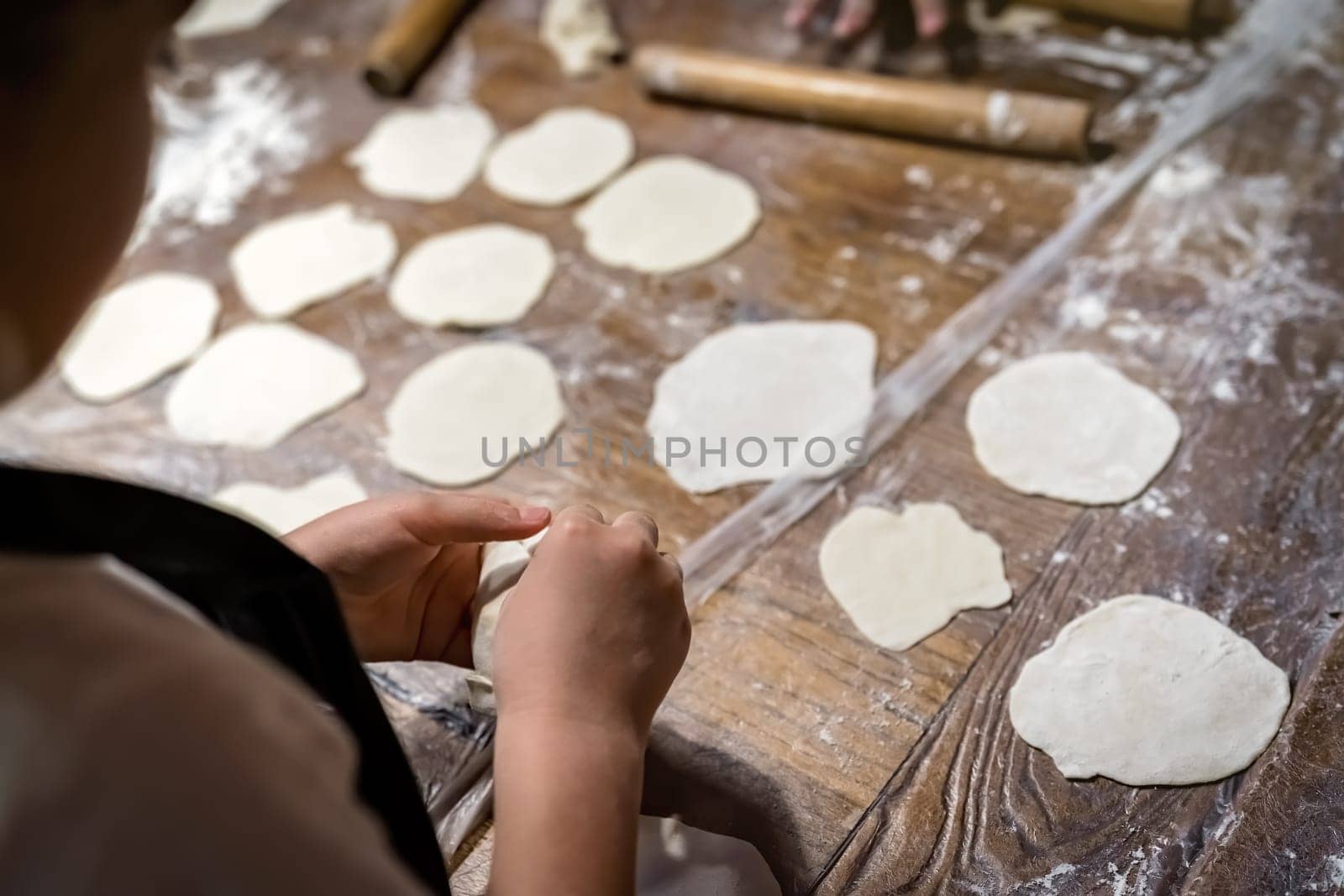Girl learning to make traditional chinese dumplings during cooking class in a travellers hostel, Chengdu, Sichuan Province, China