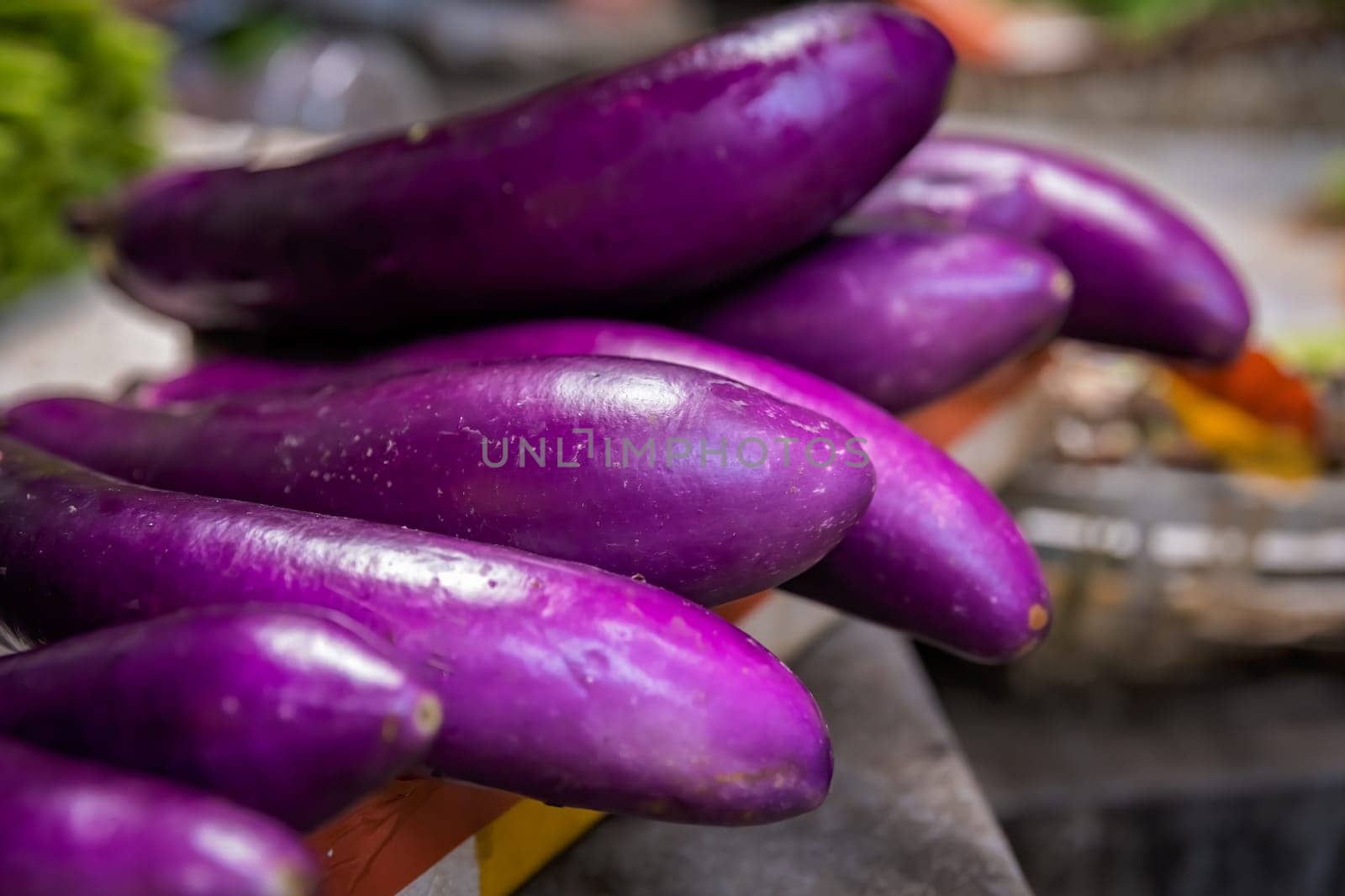 Pile ripe purple aubergines on sale on a street farmers market in China