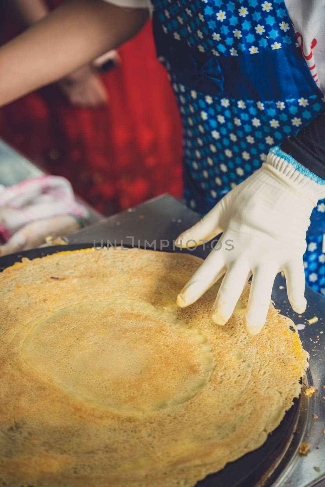 Woman making savoury egg pancakes in a small local street outlet bakery in Yichang town, China