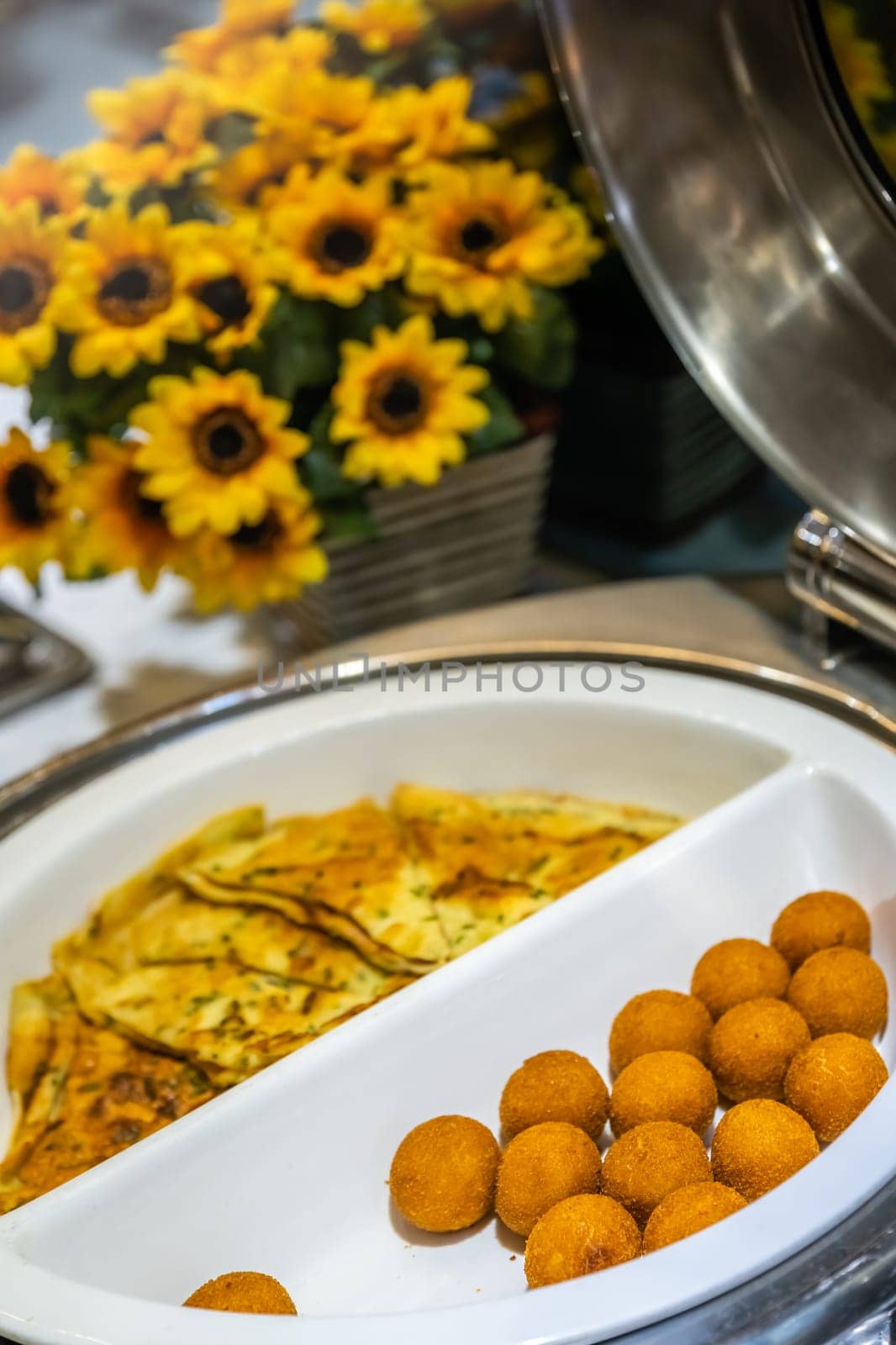 Egg pancakes and egg balls in breadcrumb in a serving bowl as a asian style breakfast buffet on the table in hotel cafeteria, China