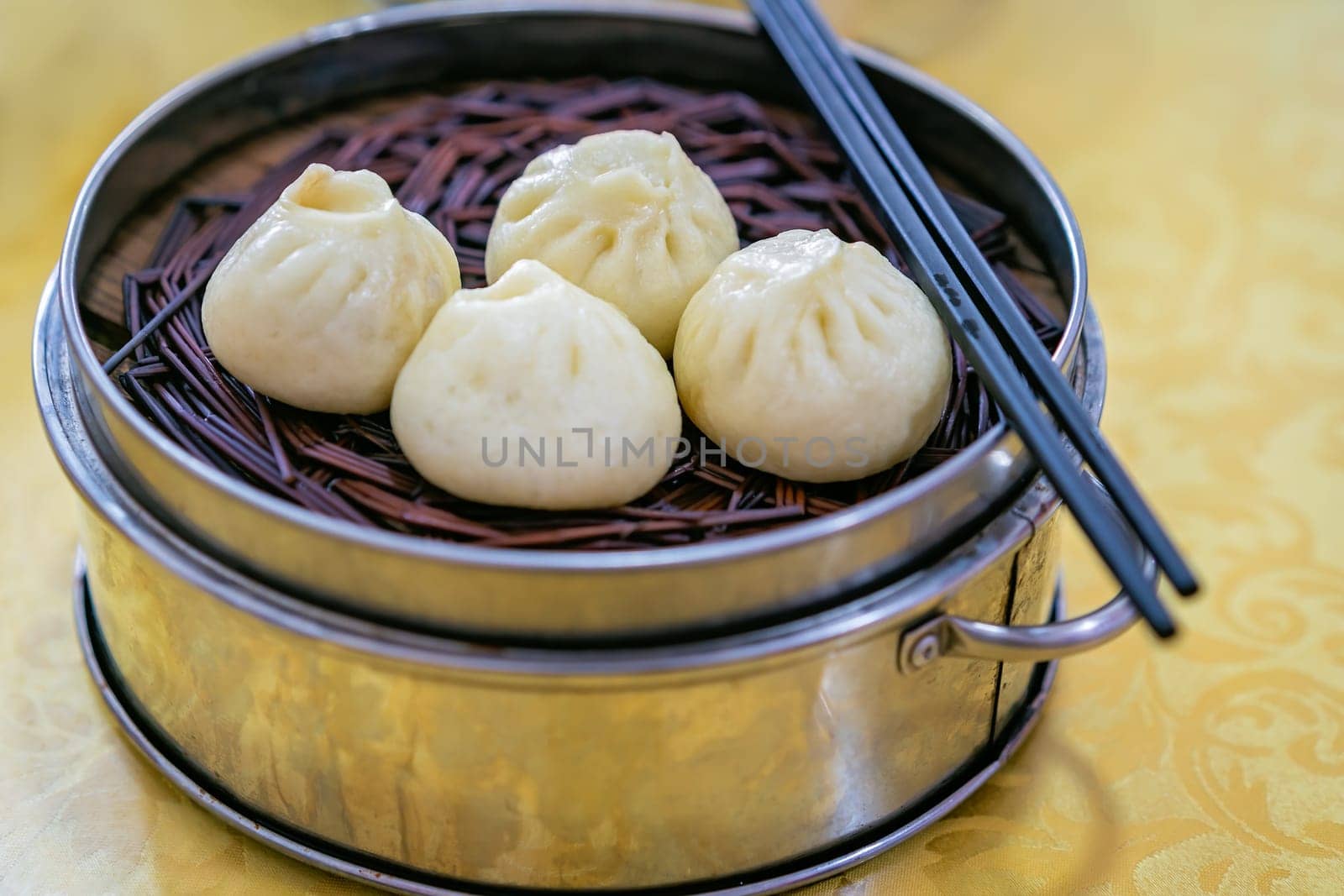 Delicious traditional chinese Baozi buns, steamed buns filled with ground pork meat and cabbage prepared on hot steam, steamed. China