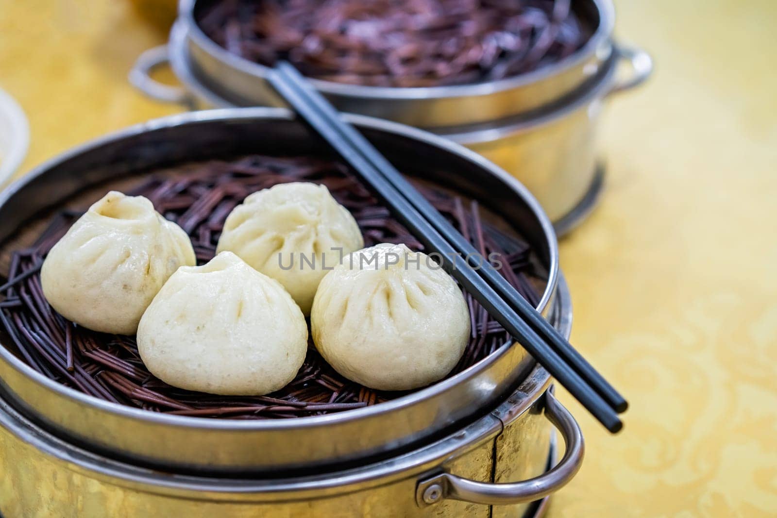 Delicious traditional chinese Baozi buns, steamed buns filled with ground pork meat and cabbage prepared on hot steam, steamed. China
