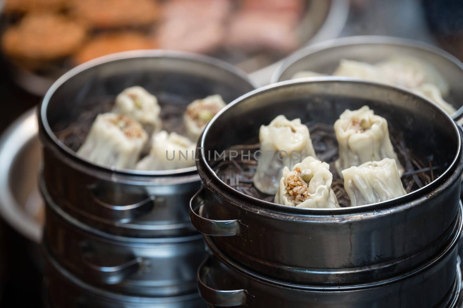 Delicious traditional chinese dumplings steamed and filled with pork meat, prepared on hot steam, China
