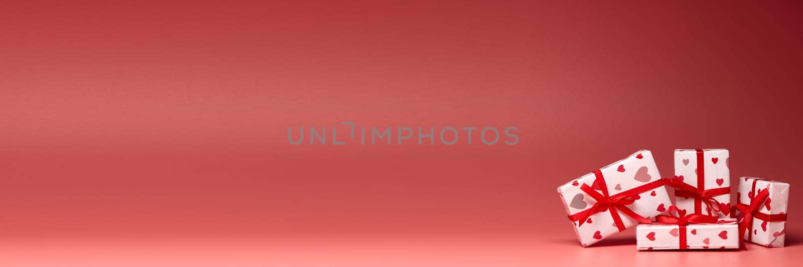 Gift boxes on pink background with copy space. Valentine's Day. Mother's day, wedding, women's day. Extra wide panorama banner background