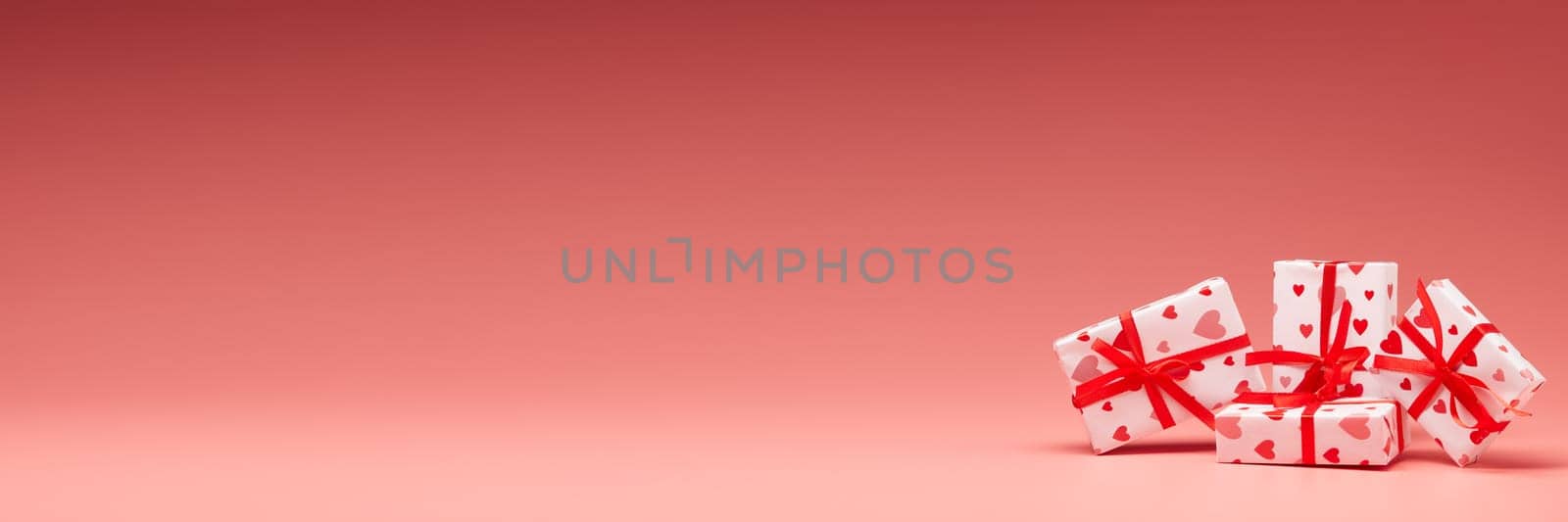 Gift boxes on pink background with copy space. Valentine's Day. Mother's day, wedding, women's day. Extra wide panorama banner background