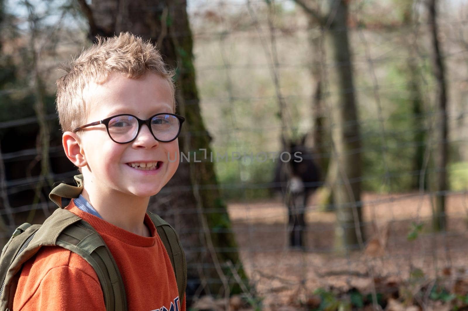 a portrait of young boy with glasses
