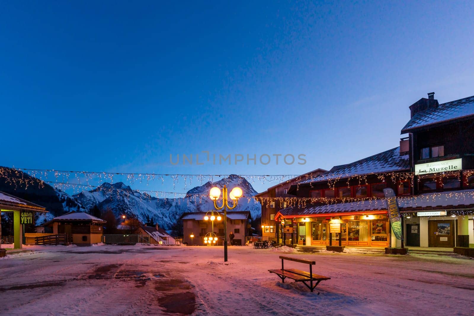 Les deux Alpes, Alps, France, January 2017 Nightlife in alpine village with traditional wooden houses, shops and restaurants. Popular ski destination