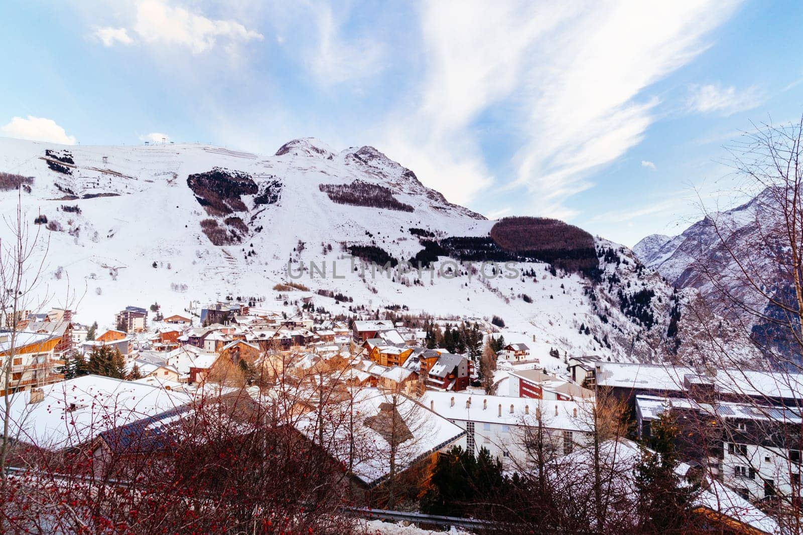 View on alpine village and mountain range, Les deux Alpes. French Alps, Isere department in winter time. Popular ski and winter sport destination