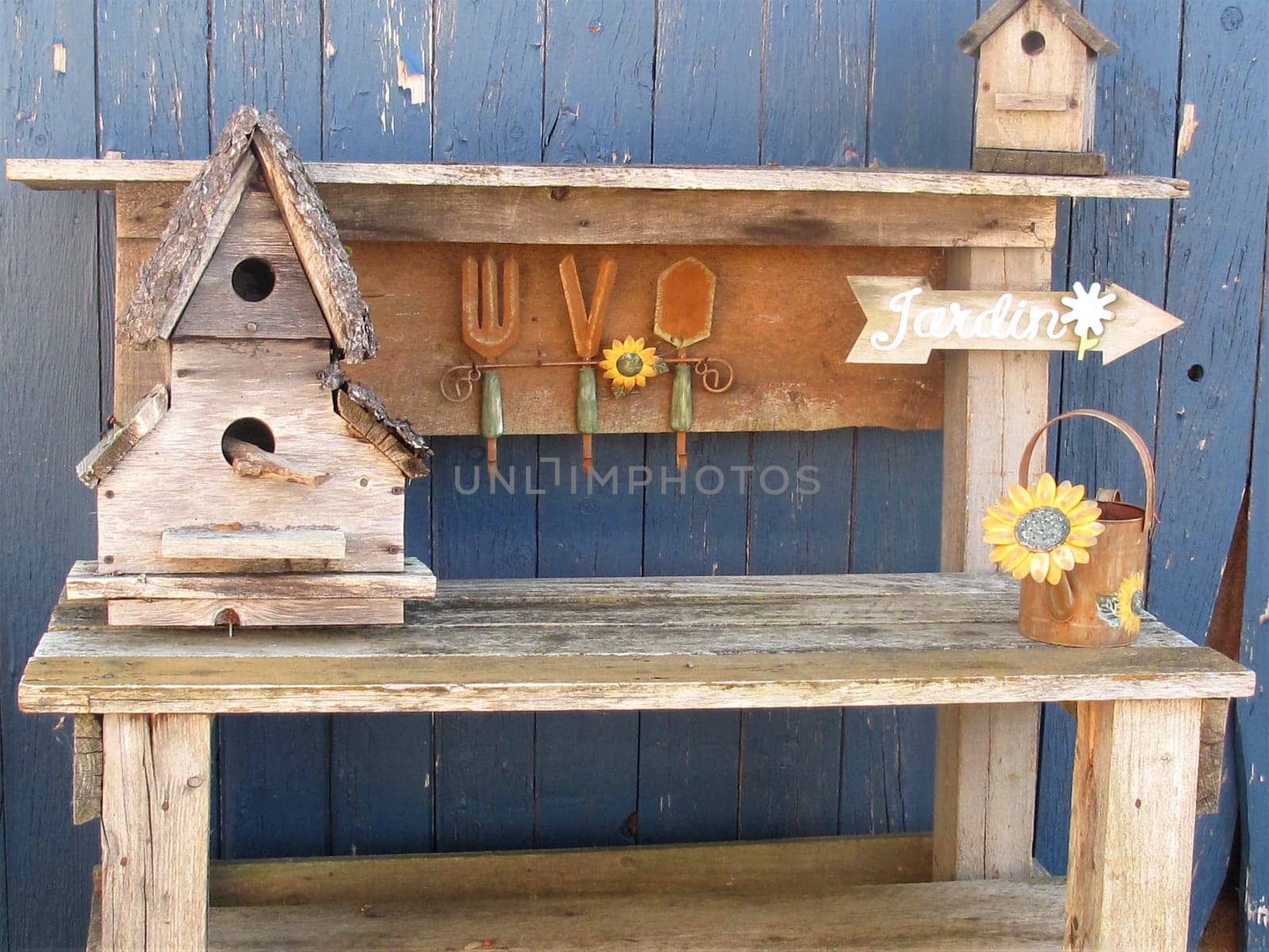 Outdoor wood table with decorations against blue wall