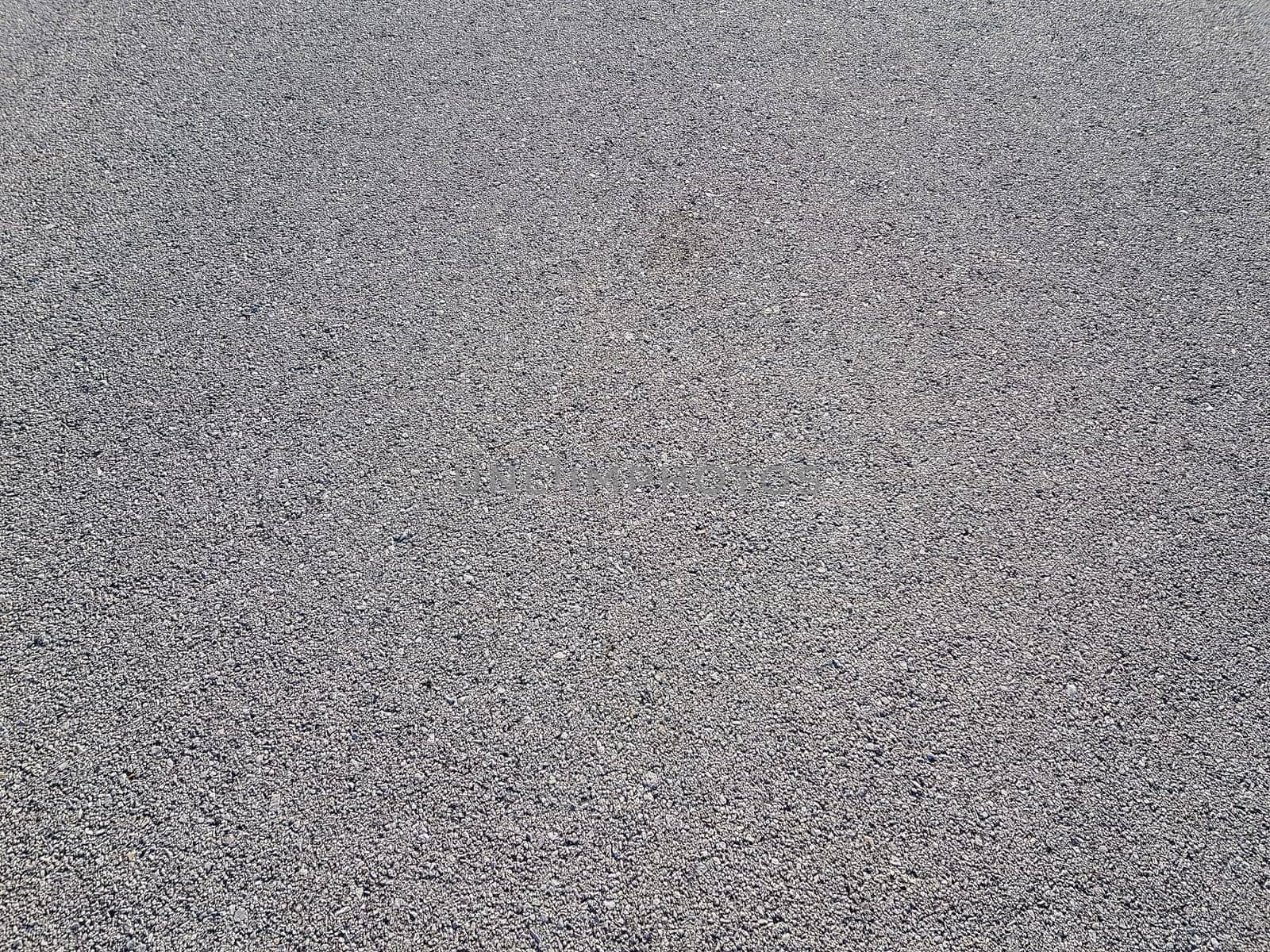 Light gray asphalt for pavement. The surface of the asphalt is smooth. Tarmac construction material. Good for neutral backgrounds.