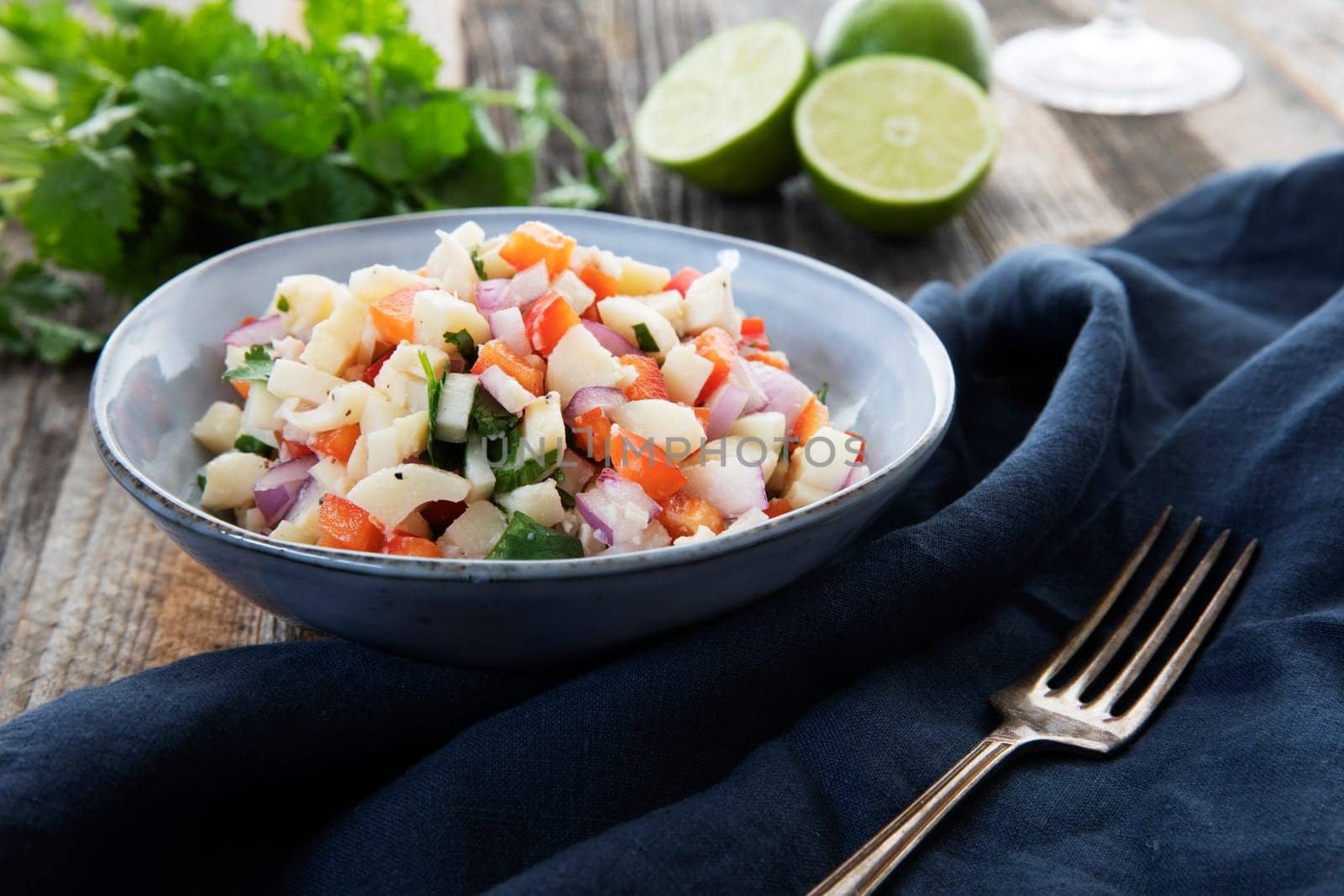 Vegan salad with hearts of palm, red onion, pepper, cilantro and lime dressing.