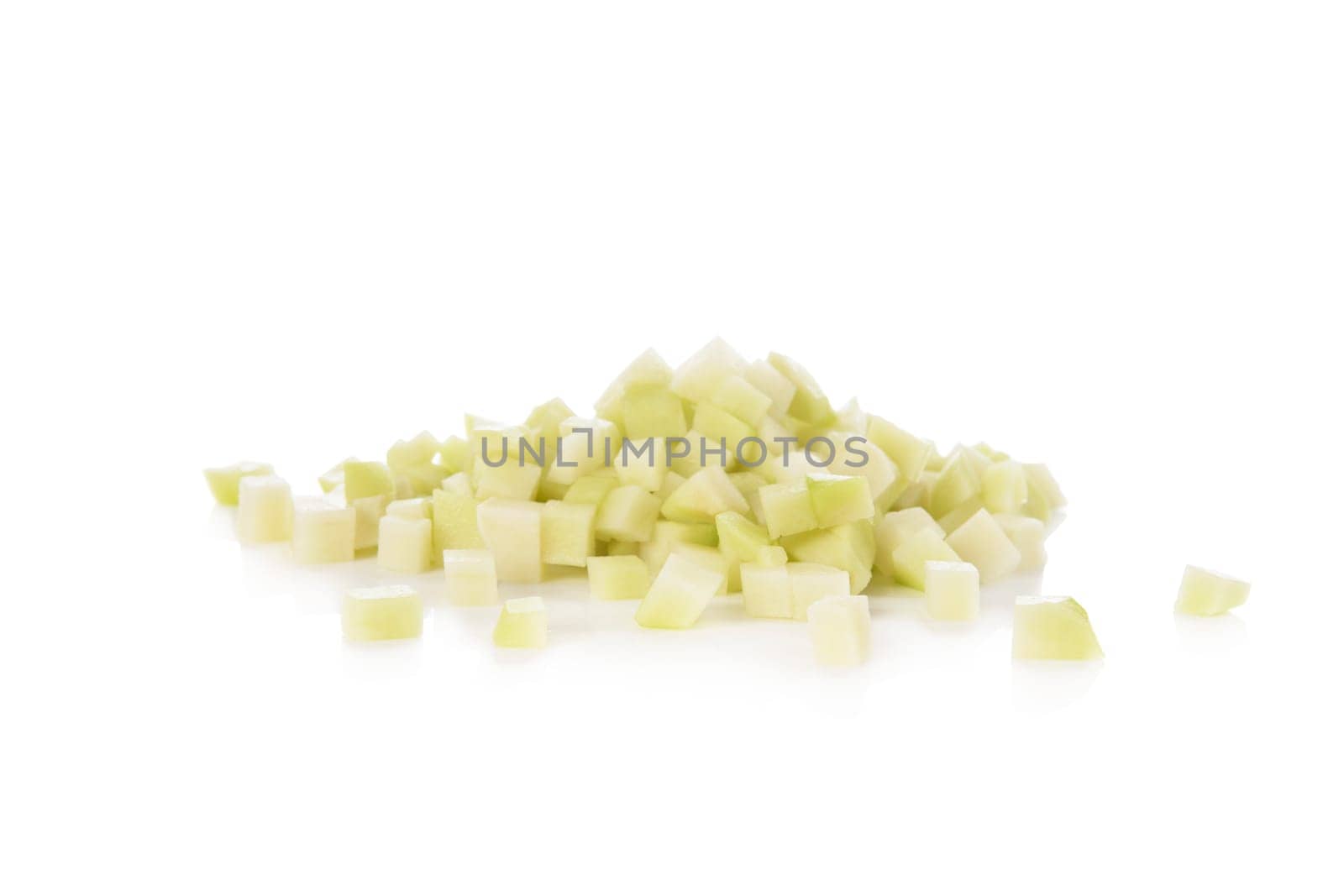 Fresh cubed chayote squash isolated on a white background.