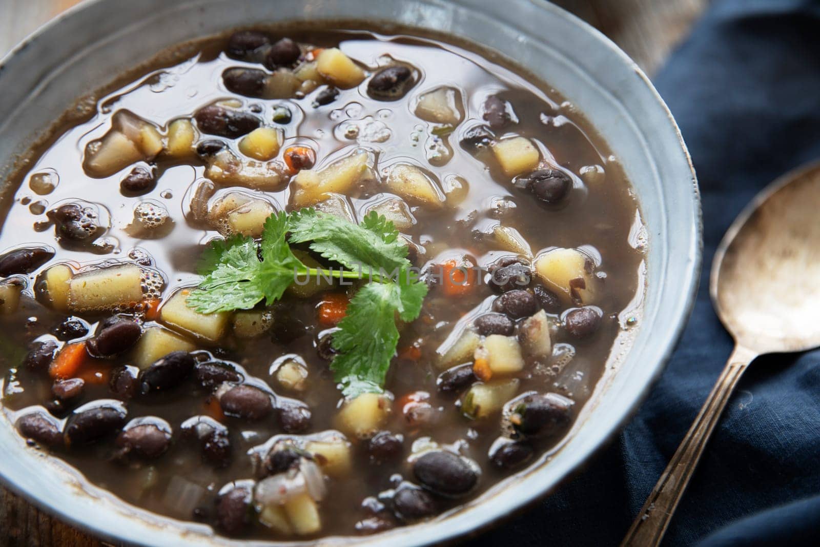 Black bean and potato soup in blue bowl