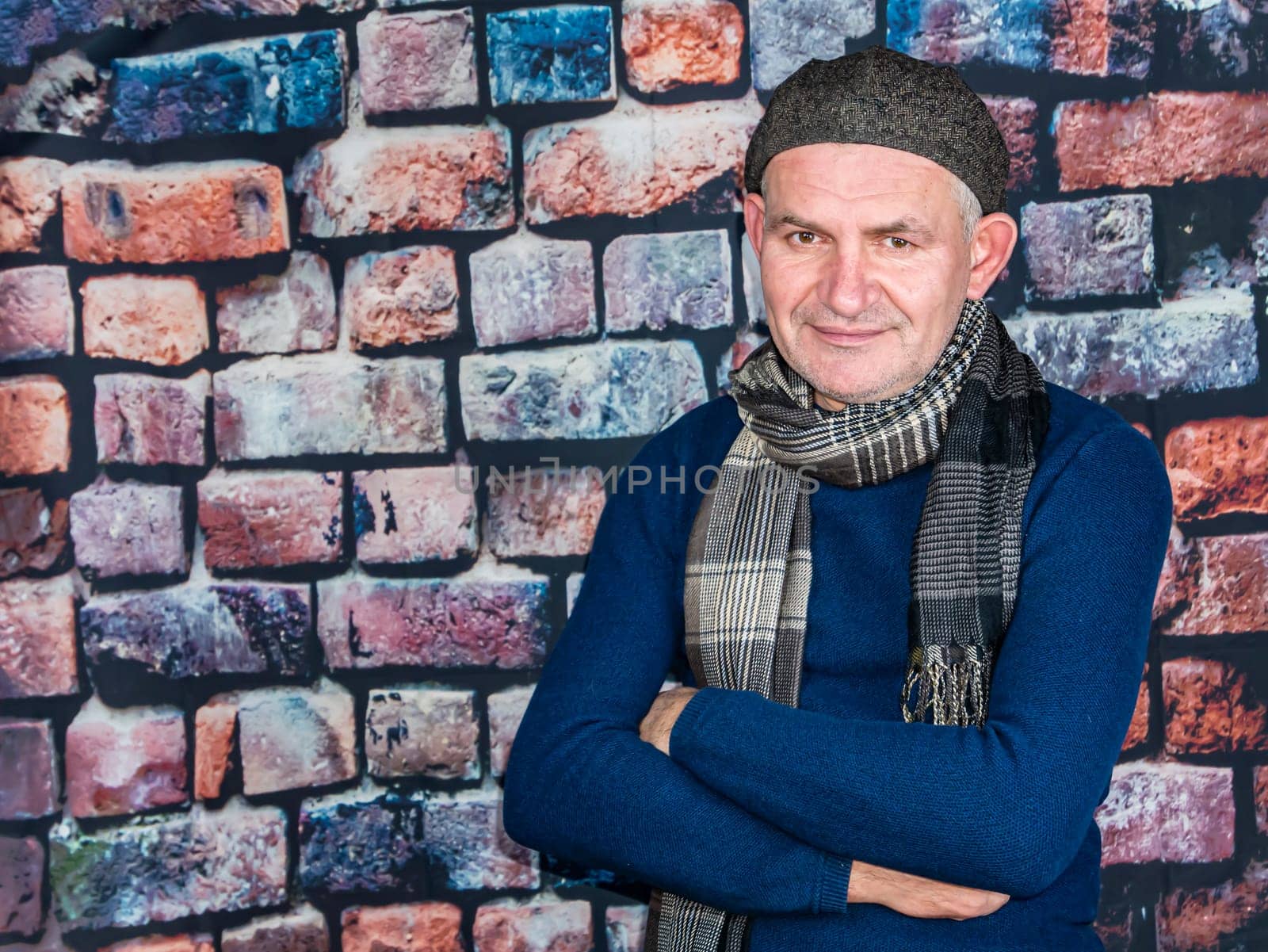 A man in a cap against a brick wall. People. Place for text. Background image. Photo model. Fashion.