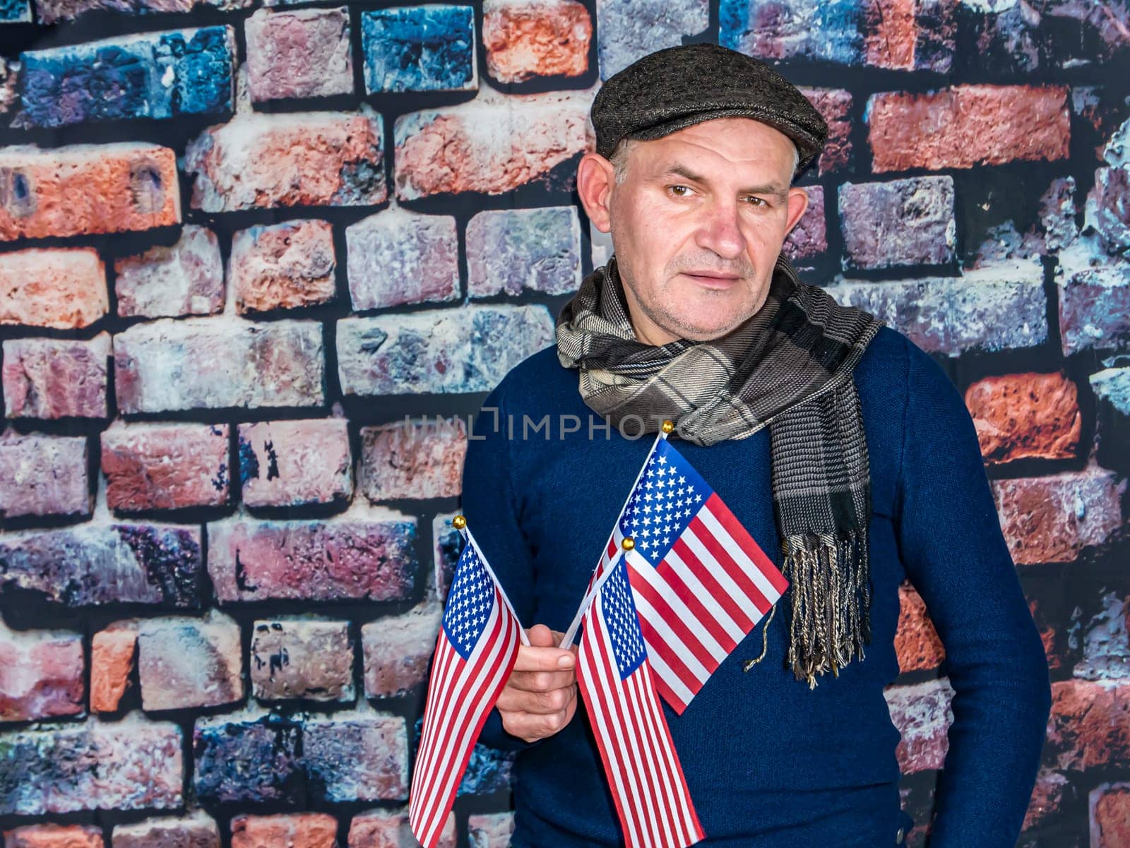 A man with an American flag in his hand on Independence Day. Independence Day of America. Elections. Patriot. People. Place for text. Background image. Photo model.