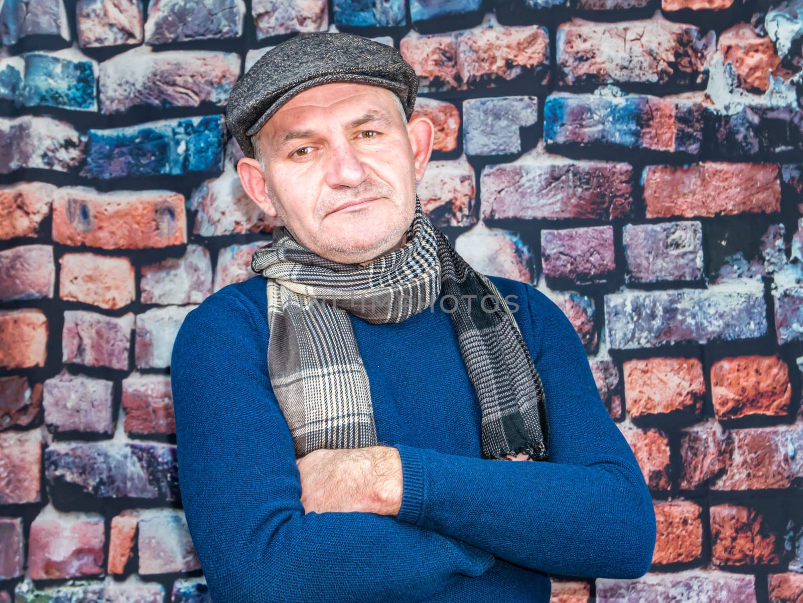 A man in a cap against a brick wall. People. Place for text. Background image. Photo model. Fashion.