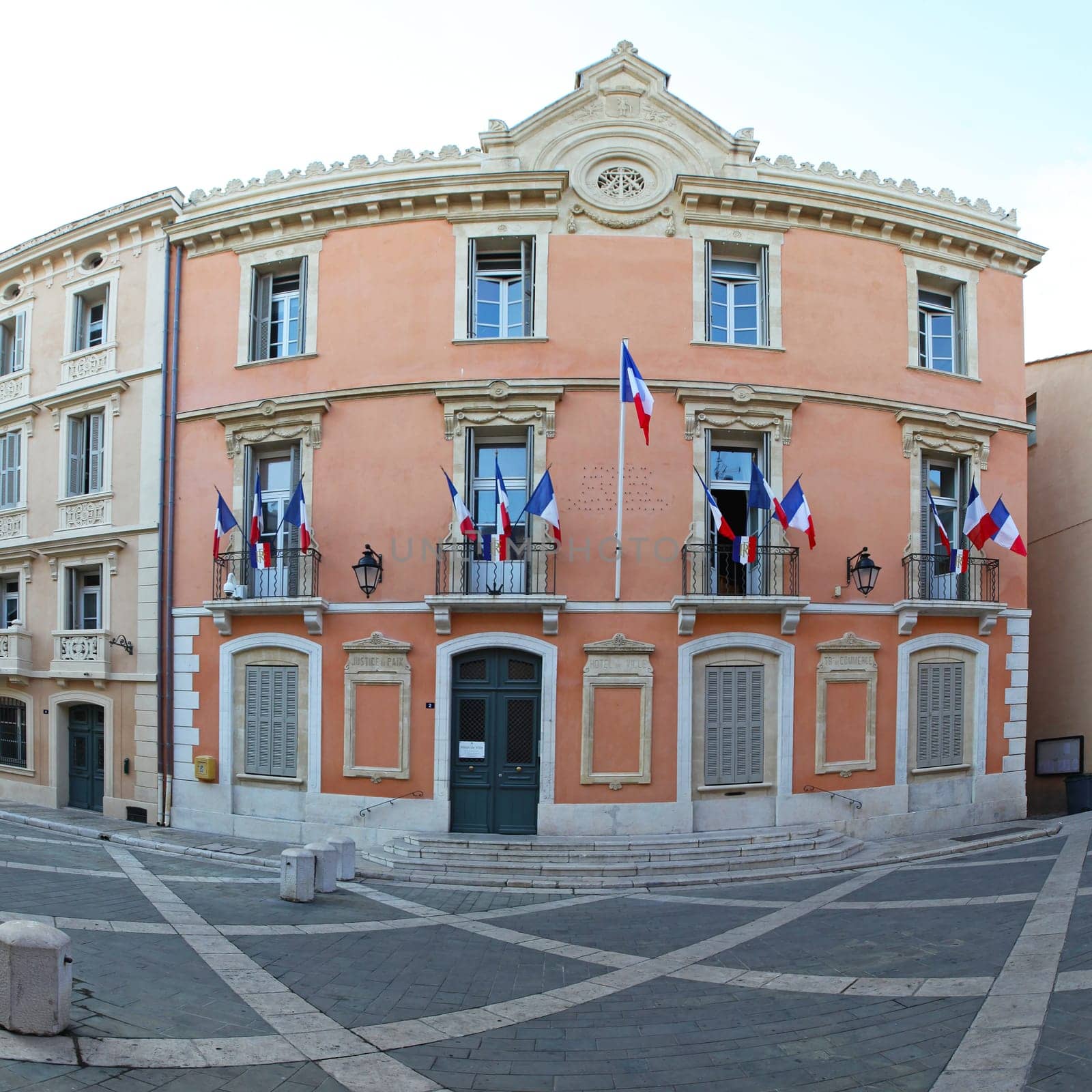 SAINT TROPEZ, FRANCE - JULY 12: Hotel de Ville in Saint Tropez on JULY 12, 2013. Luxury hotel de Ville with French flags in Saint Tropez, France.