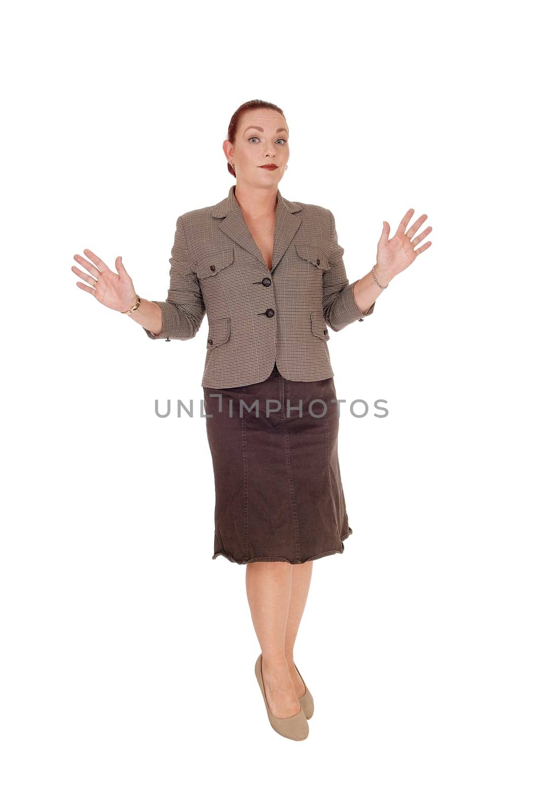 A serious looking woman in a brown jacket standing and holding her.hands up, I don't know anything, isolated for white background.