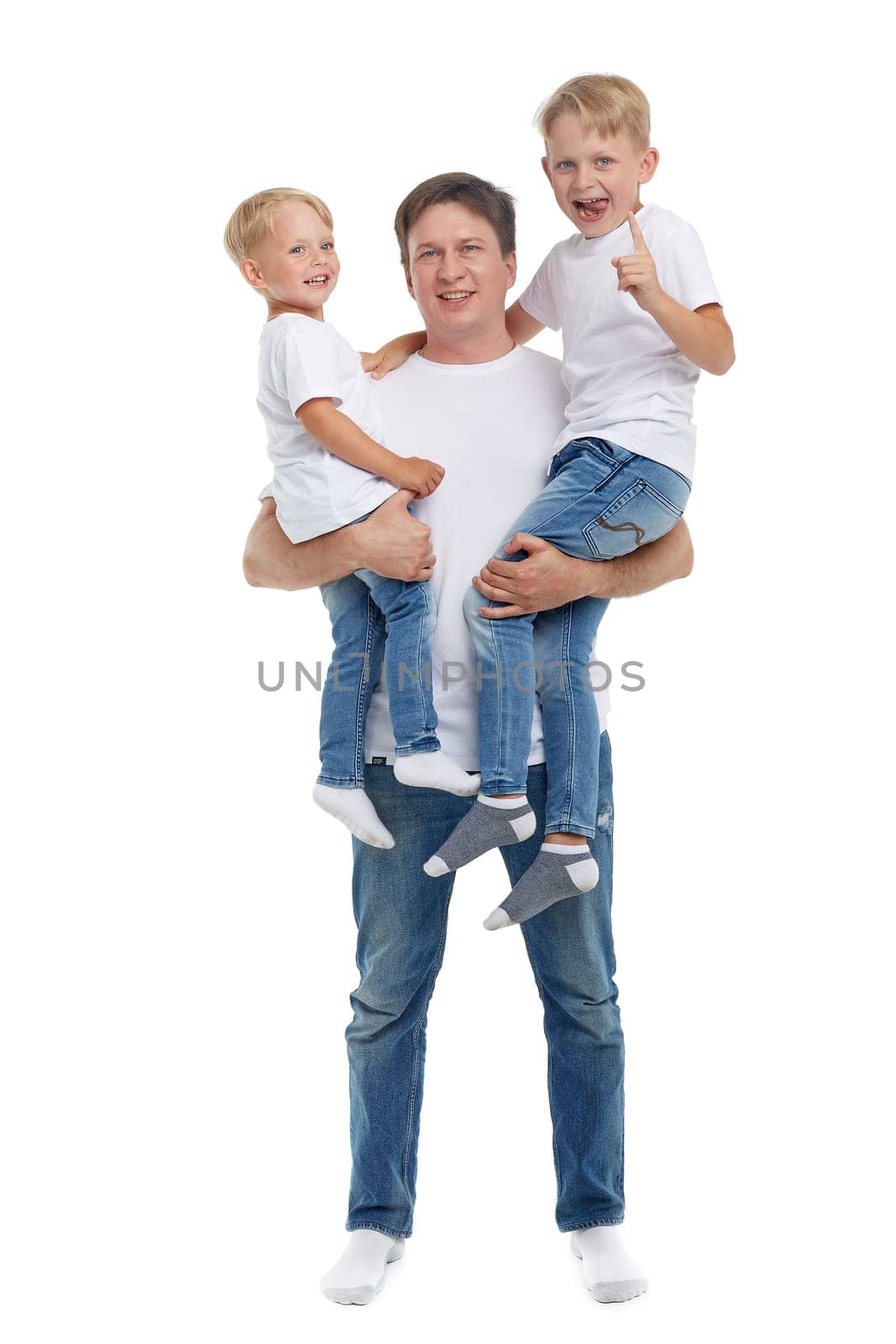 Friendly family. Young man with two children stand isolated on a white background. Happy parent. Father with two sons. Concept of people and family