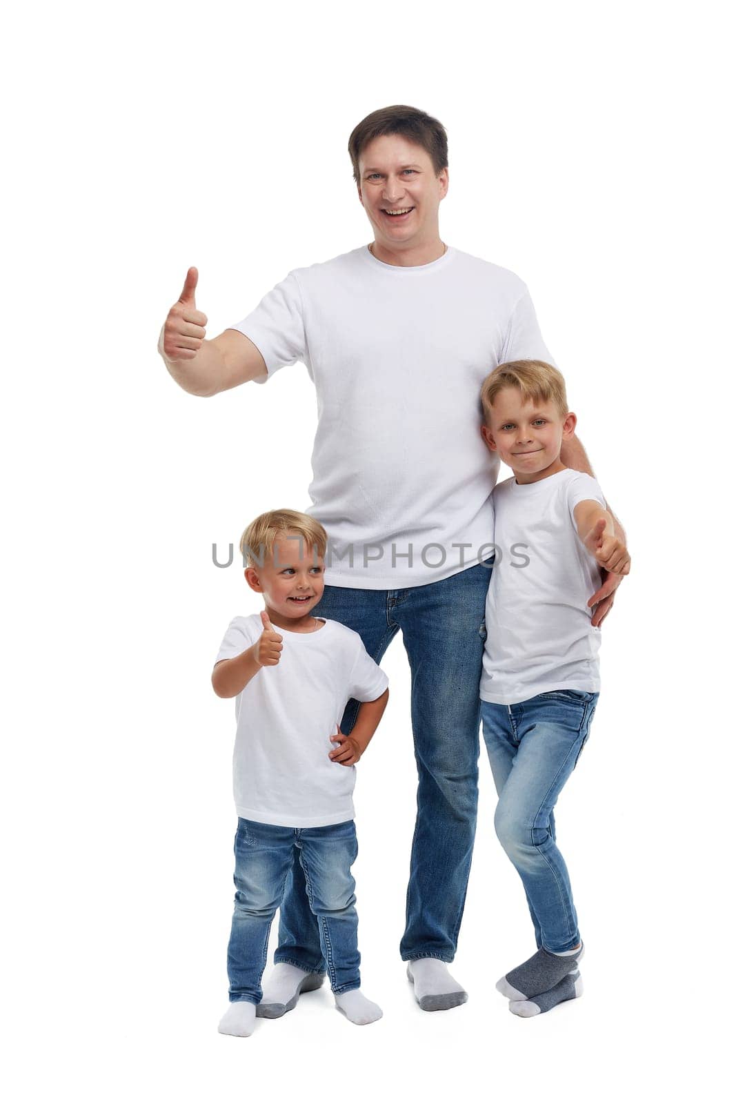 Friendly family. Young man with two children stand isolated on a white background. Happy parent. Father with two sons. Concept of people and family