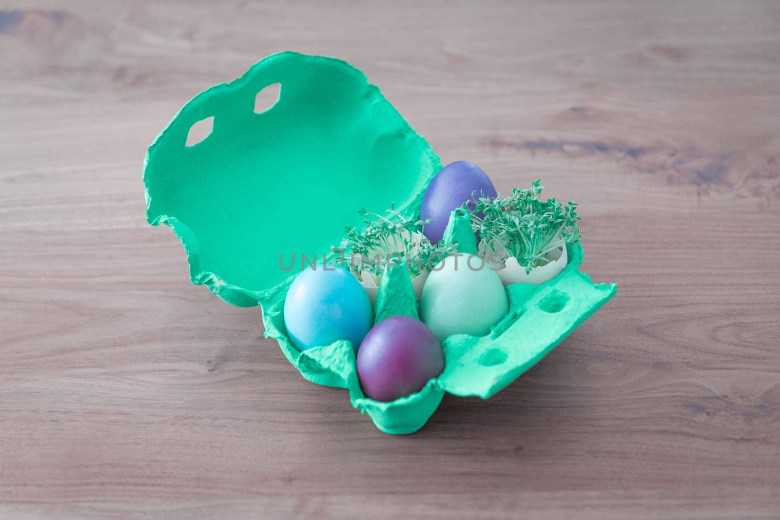 Beautiful decoration easternest basket with painted eggshells for celebration. Lovely traditional gift design on wooden background.