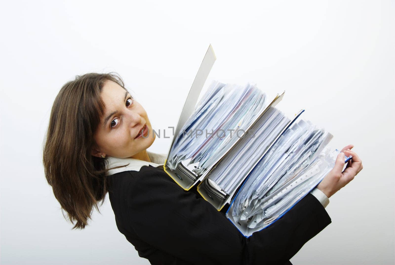 Young attractive business woman overloaded with heavy files